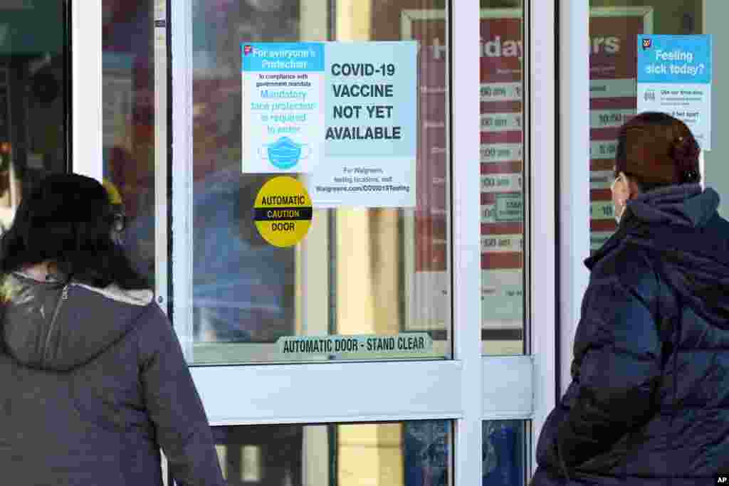 Pacientes con máscaras chequean que la vacuna contra el Covid-19 no ha llegado todavía a un Walgreens en Northbrook, ilinois.